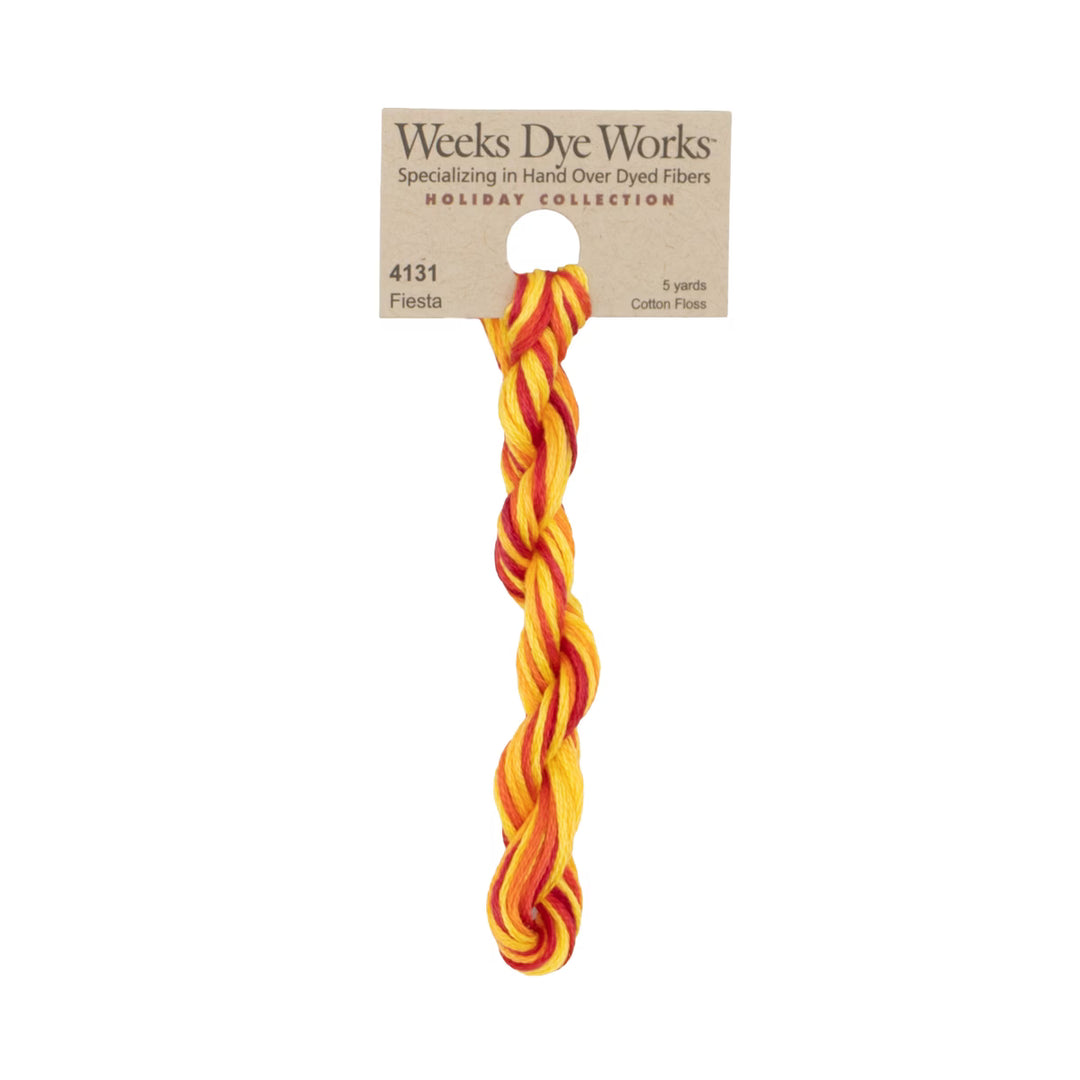 A single twisted cotton fiber bundle in a bright orange and yellow pattern, attached to a kraft paper hanger card from Weeks Dye Works, shown against a plain white background.