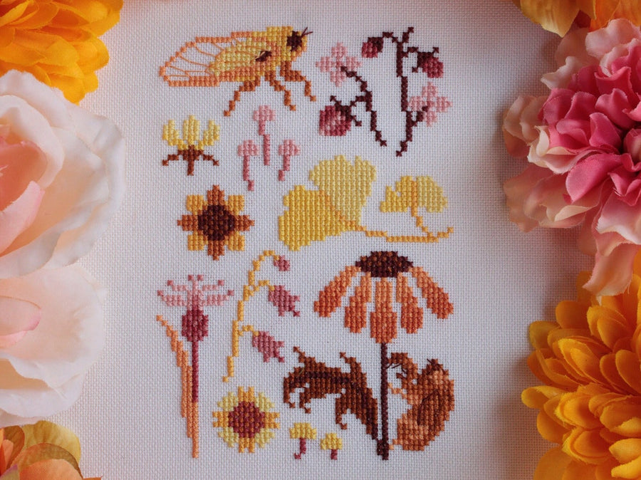 assortment of yellow and orange flowers and bugs