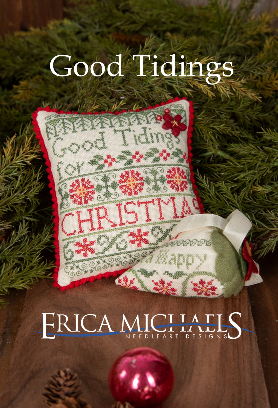 Decorative pillow with Christmas-themed embroidery on a green leaf background, featuring the brand 'Erica Michaels'.