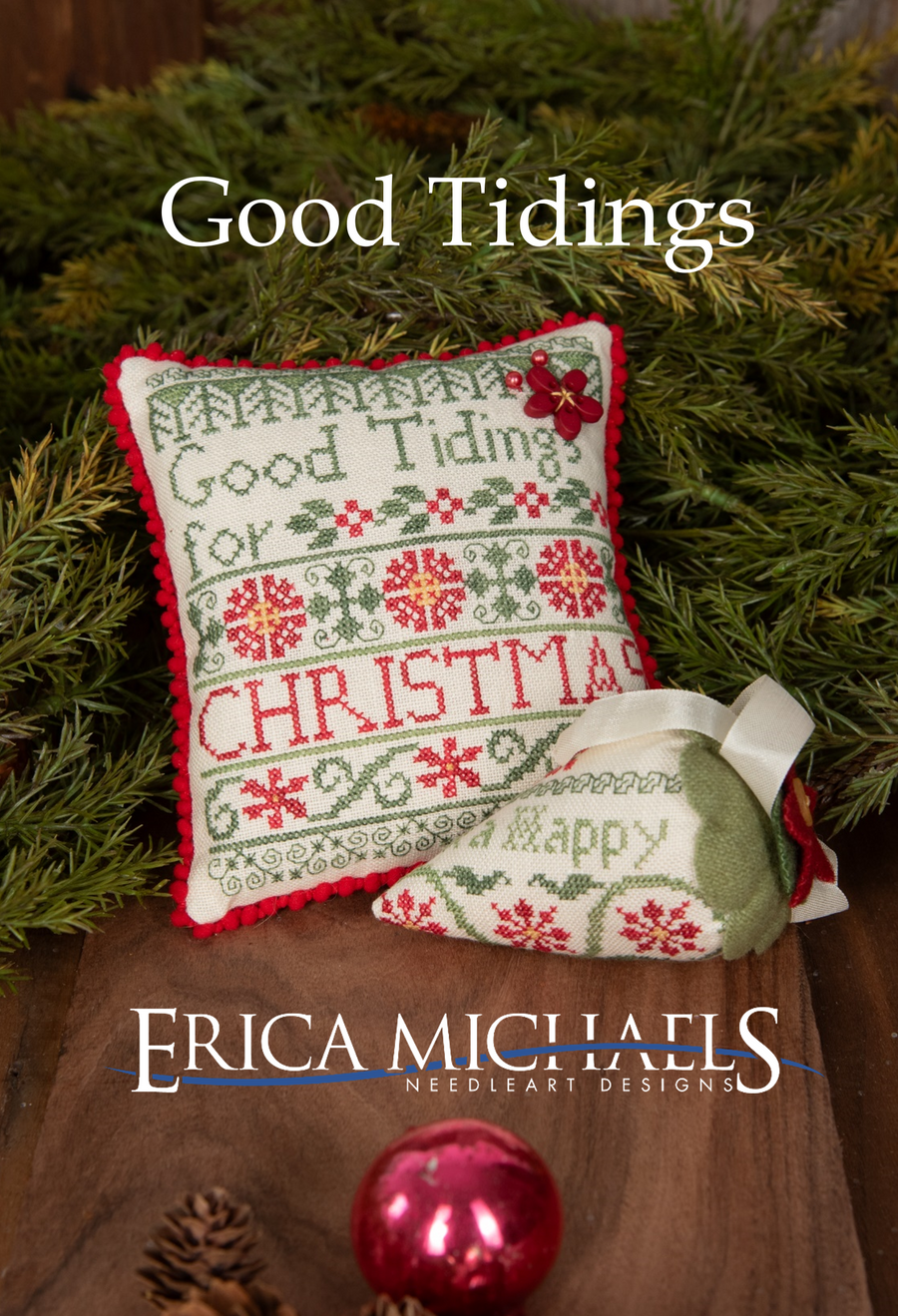 Decorative pillow with Christmas-themed embroidery on a green leaf background, featuring the brand 'Erica Michaels'.
