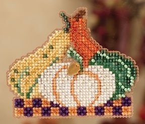 Decorative cross-stitch piece with pumpkins and berries on a neutral background