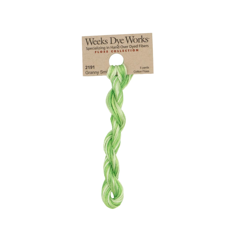 A single twisted cotton thread in light green from Weeks Dye Works Floss Collection, attached to a brown paper header card.