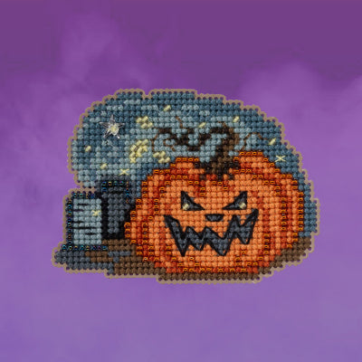 Cross-stitched design of a pumpkin with a moon and stars on a purple background