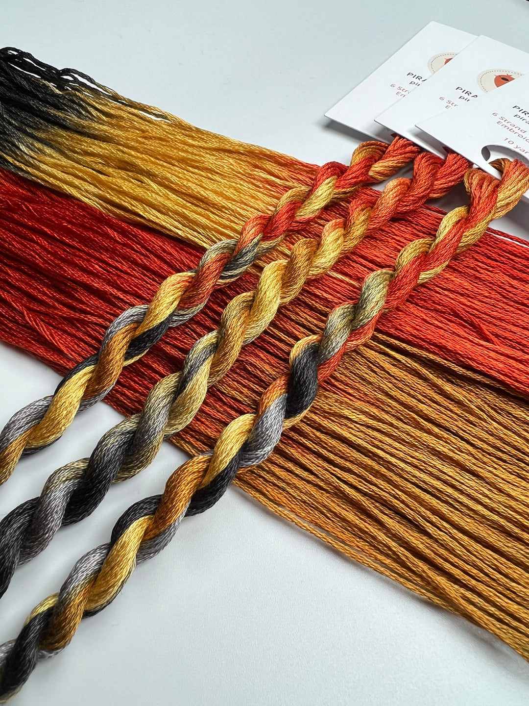 Set of braided floss in various autumn colors on a white background