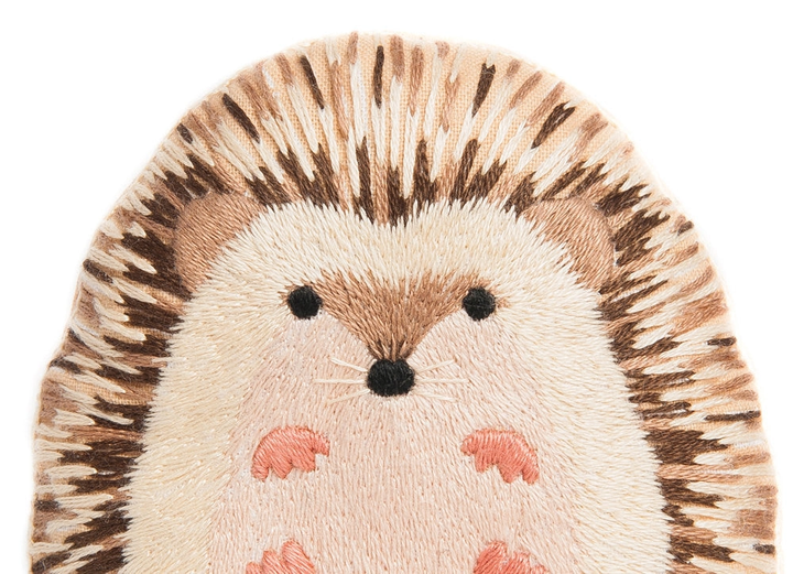 Embroidered hedgehog design on a white background