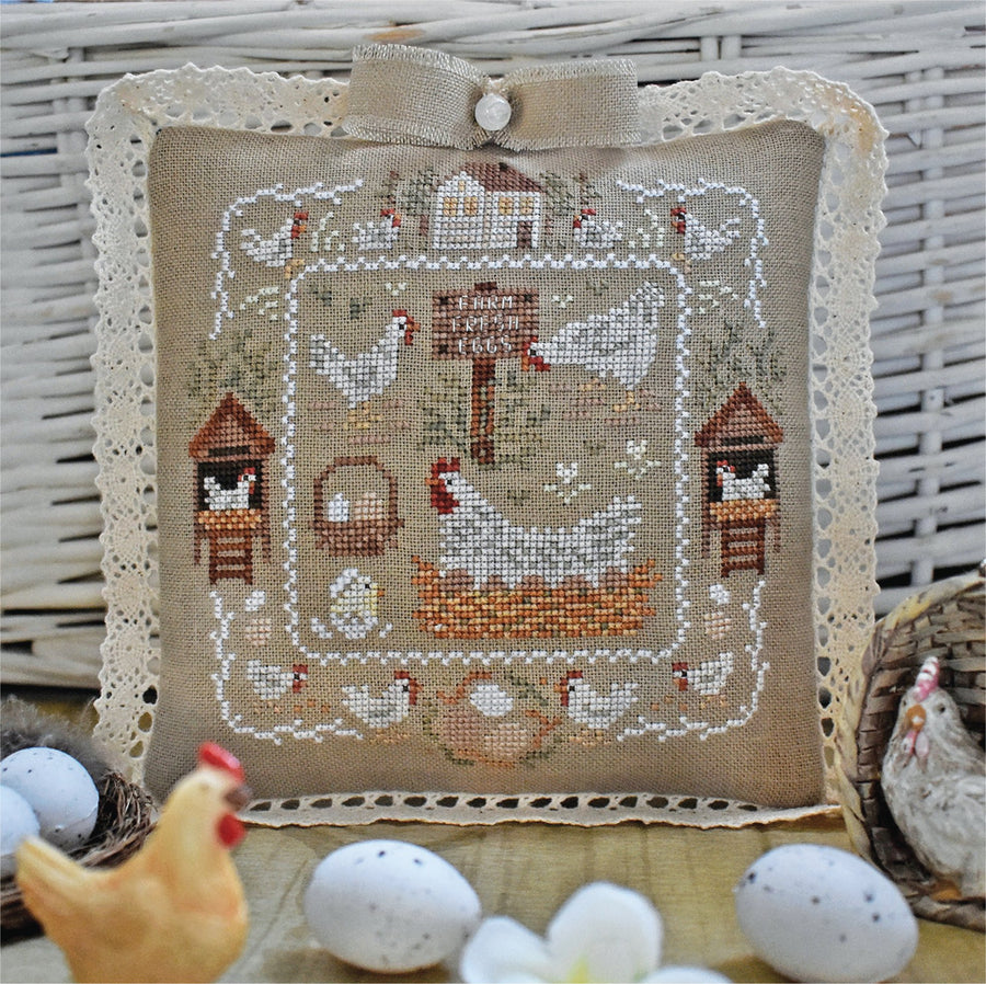 Decorative pillow with chicken farm design and eggs on a rustic background