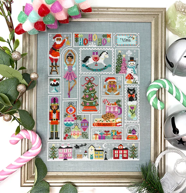Framed cross-stitch pattern with Christmas-themed designs surrounded by festive decorations.