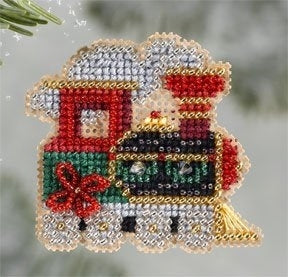 Decorative train ornament made with beads on a blurred green background