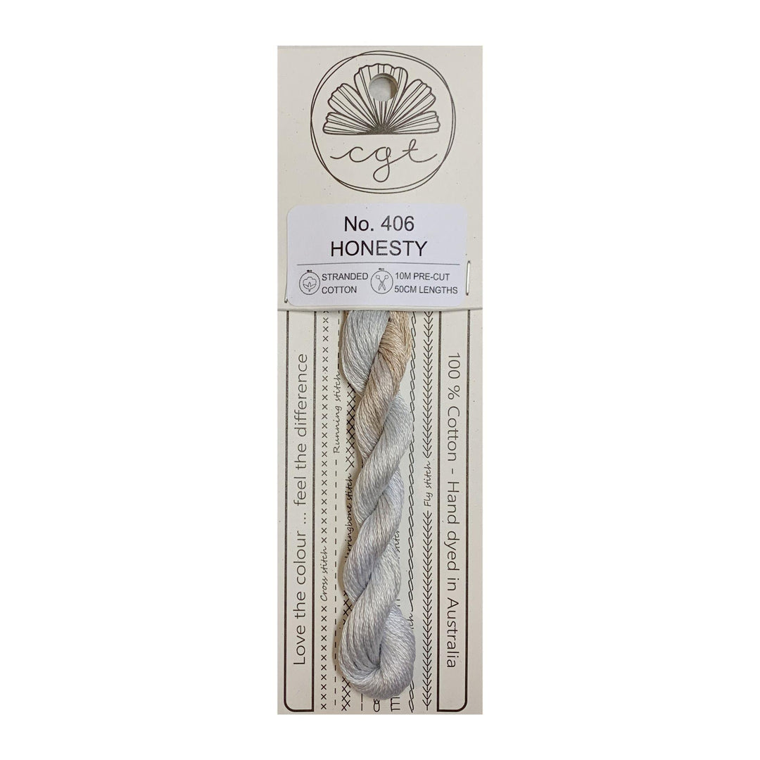 A card package of Cottage Garden Threads with a skein of hand-dyed cotton cross stitch and embroidery floss in gray color.