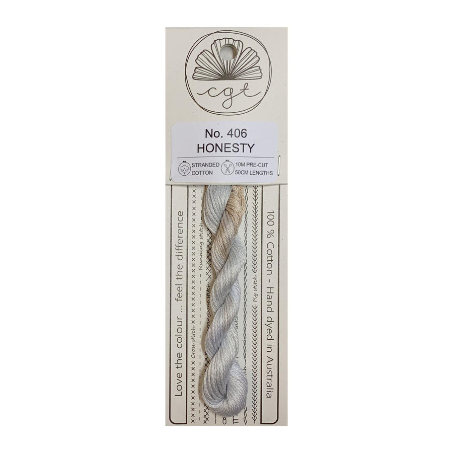 A card package of Cottage Garden Threads with a skein of hand-dyed cotton cross stitch and embroidery floss in gray color.
