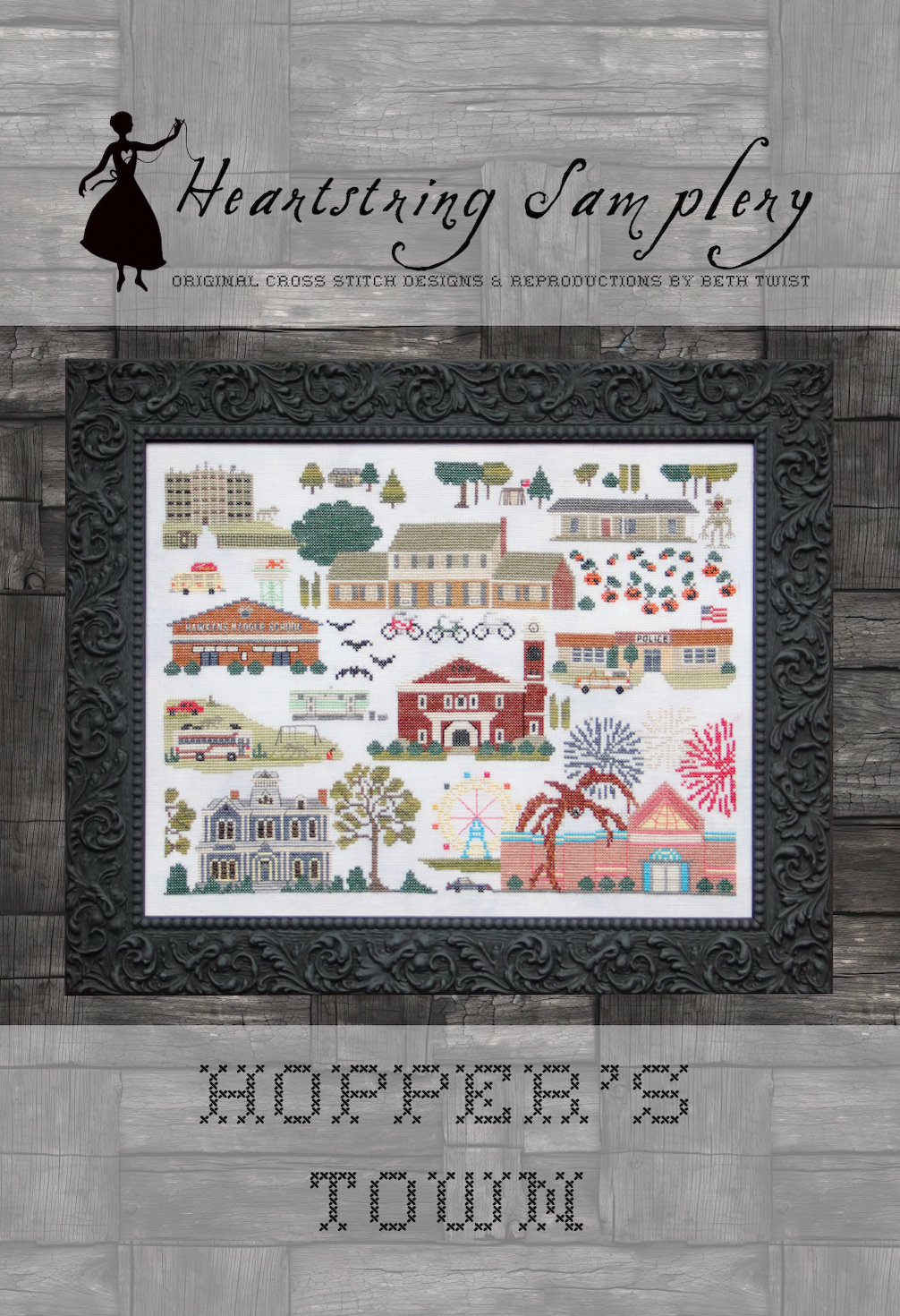 Heartstring Samplery cross stitch pattern framed on a wooden background