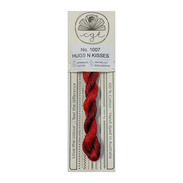 Red thread skein on a white background with packaging labeled 'Hugs N Kisses'.