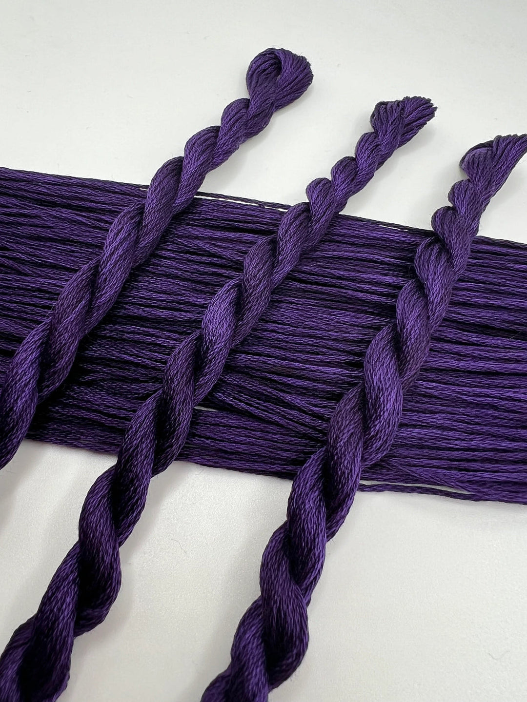 Purple braided yarn on a white background