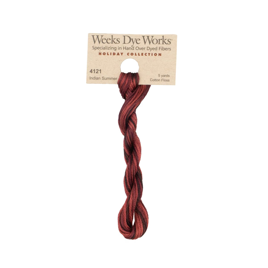 A single twisted bundle of Weeks Dye Works Indian Summer cotton floss hanging from a kraft paper header card, shown against a plain white background.