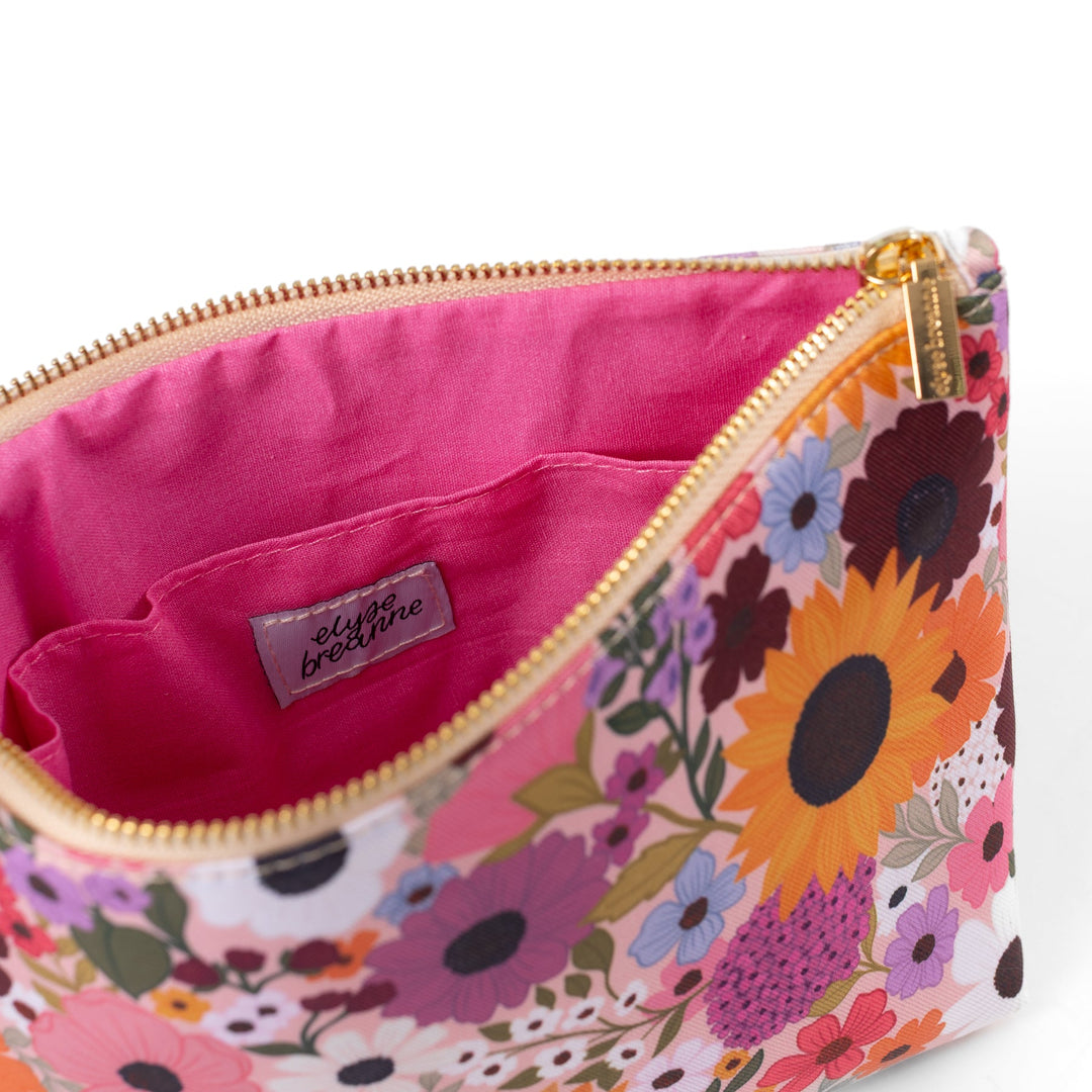 interior view of zipper pouch featuring bright pink lining fabric