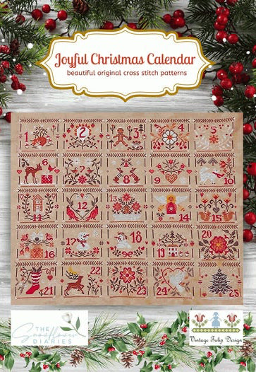 Joyful Christmas Calendar cross stitch pattern, featuring a 25-day advent calendar design with festive illustrations on a light wood background, surrounded by holiday greenery and red berries.