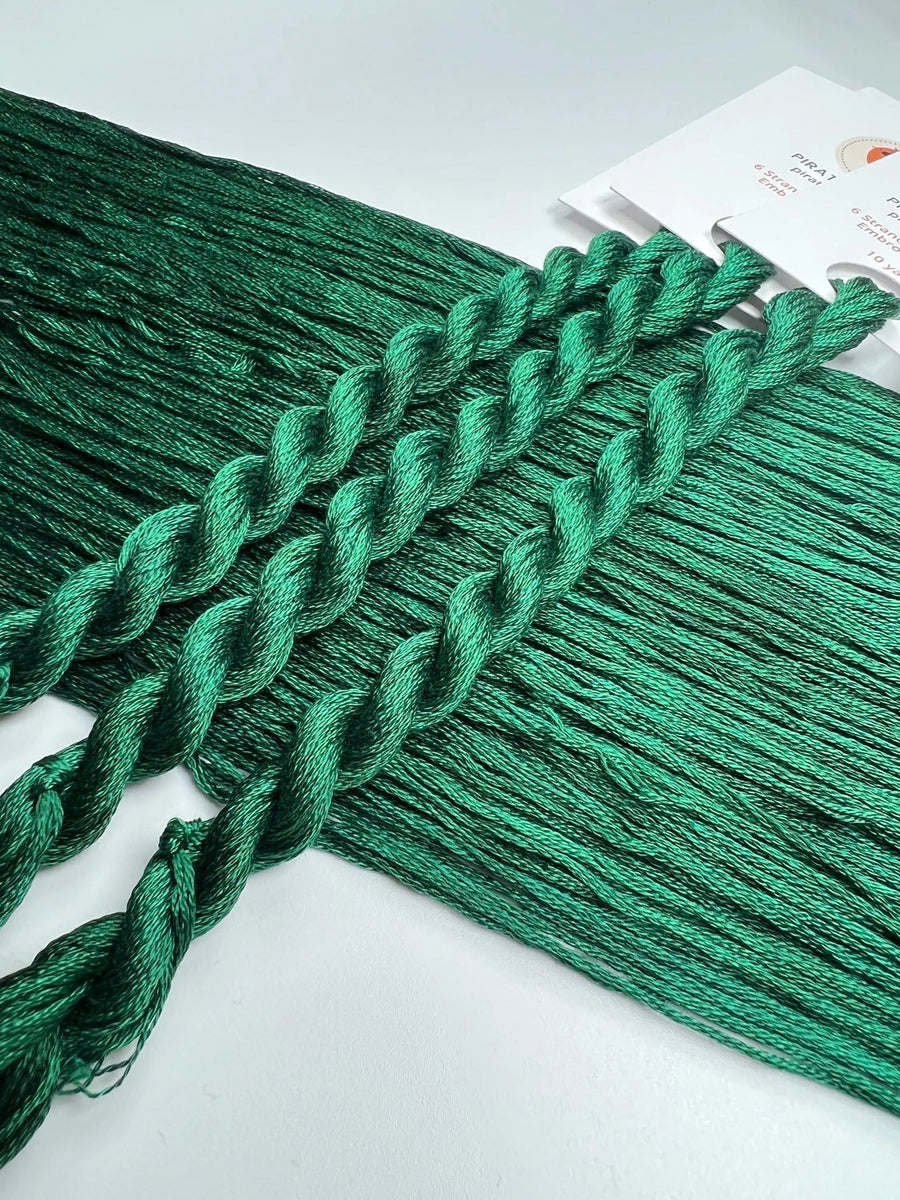 Green braided thread on a white background