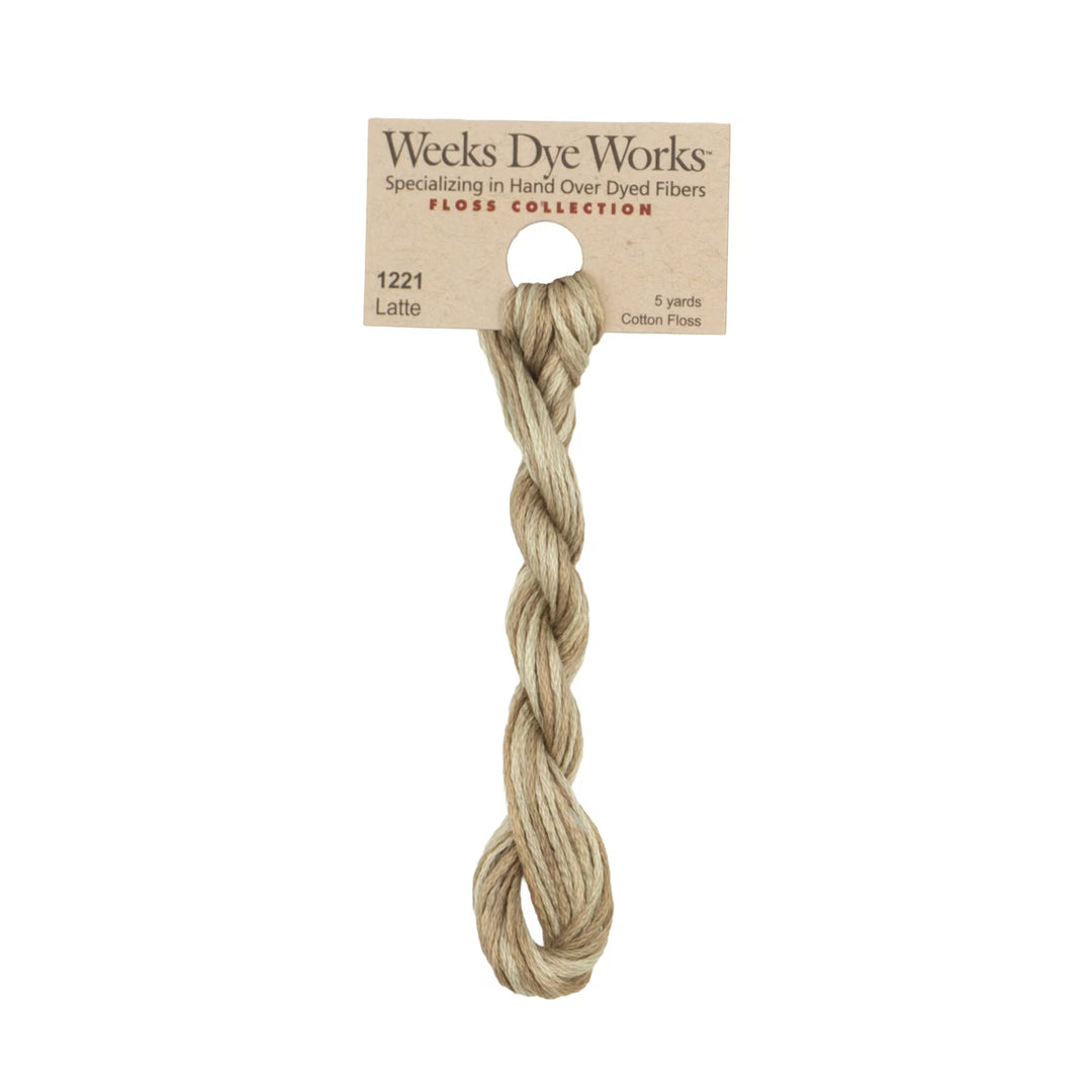 A twisted bundle of Weeks Dye Works Floss Collection cotton flax in the shade Latte, attached to its original kraft paper label card, on a solid white background.