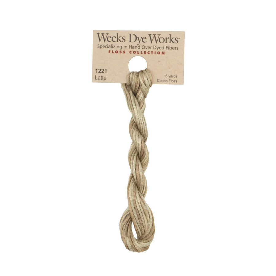 A twisted bundle of Weeks Dye Works Floss Collection cotton flax in the shade Latte, attached to its original kraft paper label card, on a solid white background.
