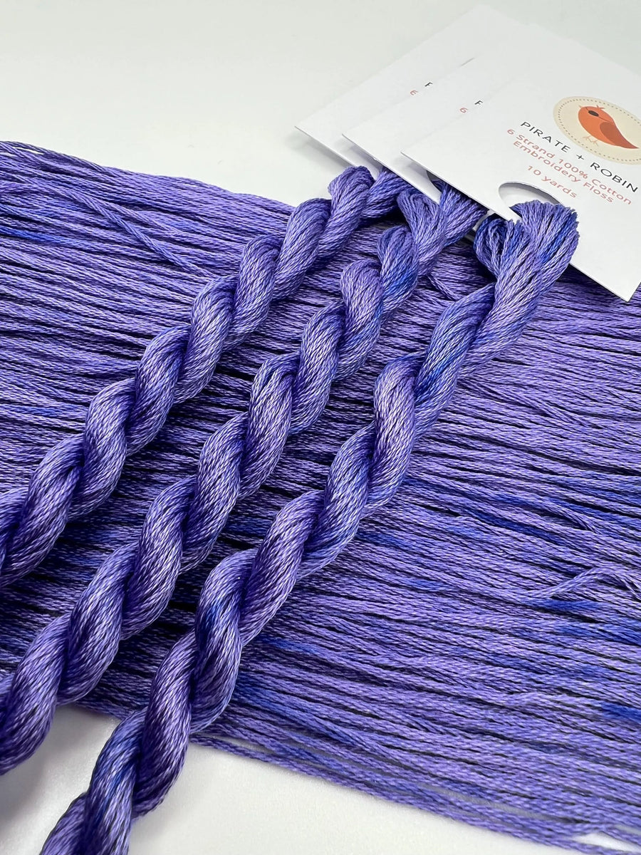 Purple thread with a brand label on a white background