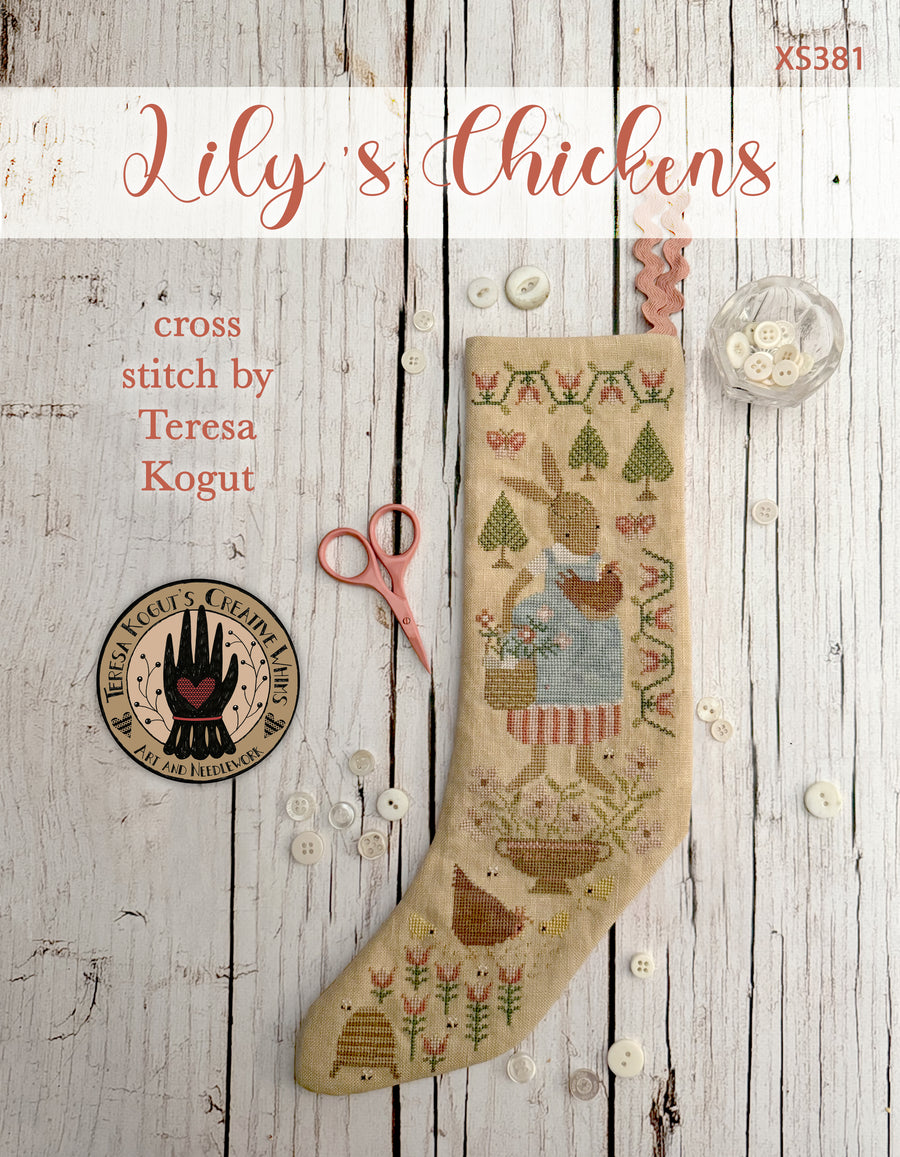 Cross stitch pattern for a stocking with a chicken design on a wooden surface.