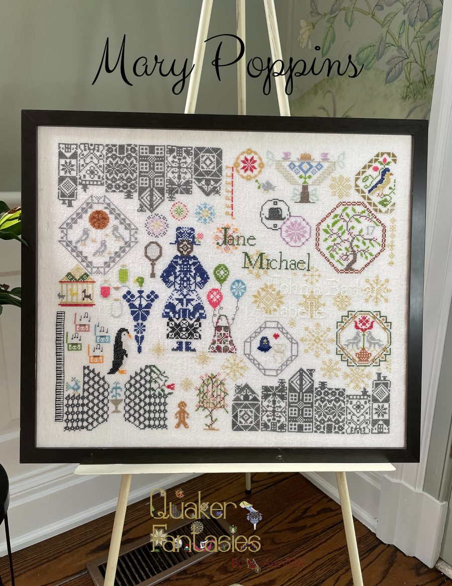 Framed cross-stitch pattern with 'Jane Michael' and decorative elements on a stand.