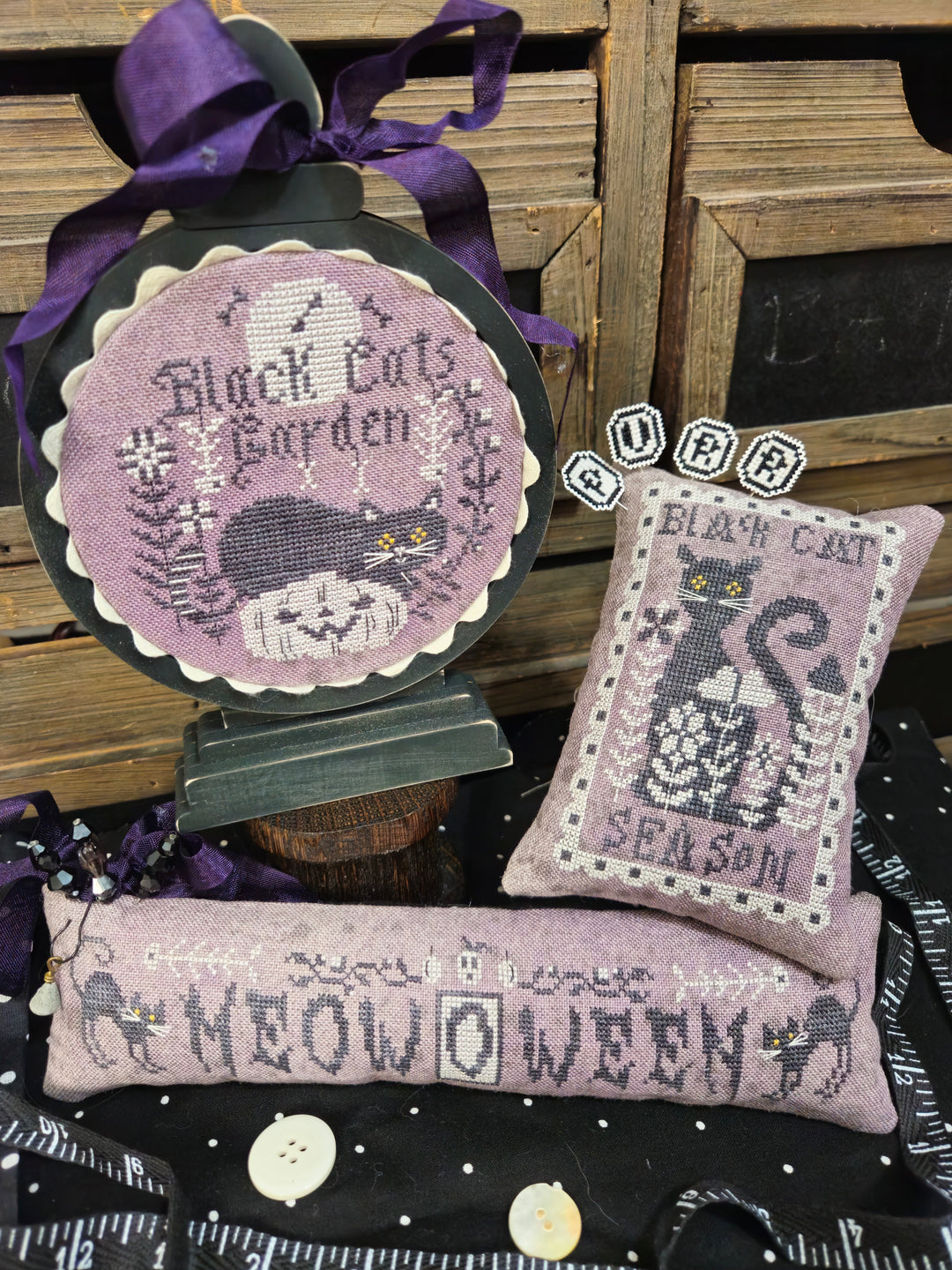 Decorative items with black cat designs and text on a wooden background