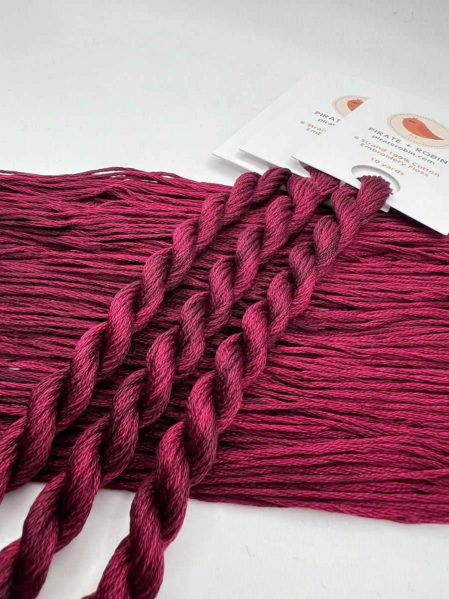 Burgundy yarn with a label on a white background