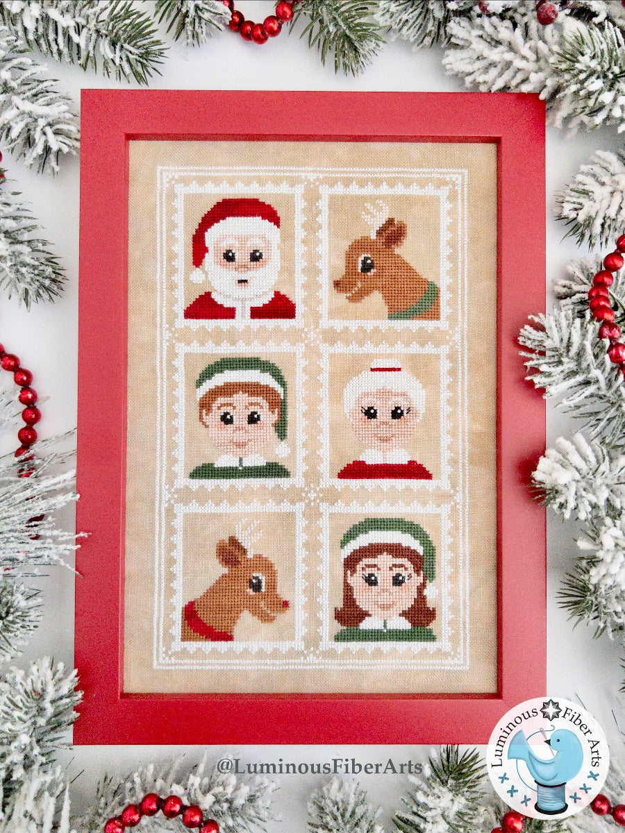 Framed cross-stitch pattern with Christmas characters surrounded by festive decorations.