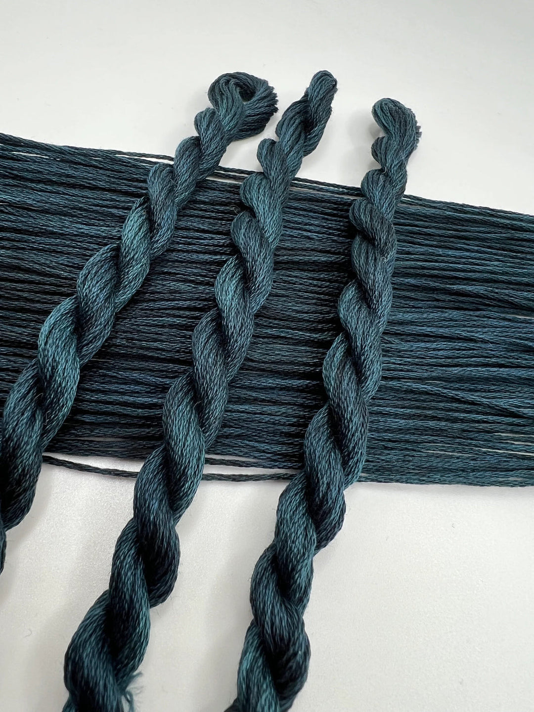 Dark blue braided yarn on a white background