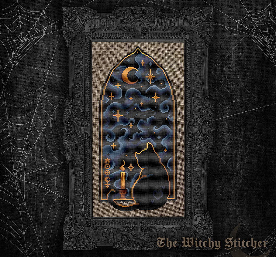 A framed gothic needlepoint or cross-stitch artwork featuring a black cat sitting by a candle under a crescent moon and stars, set against a dark ornate frame. The piece is displayed on a dark textured background with spiderweb graphics and the text 'The Witchy Stitcher' at the bottom.