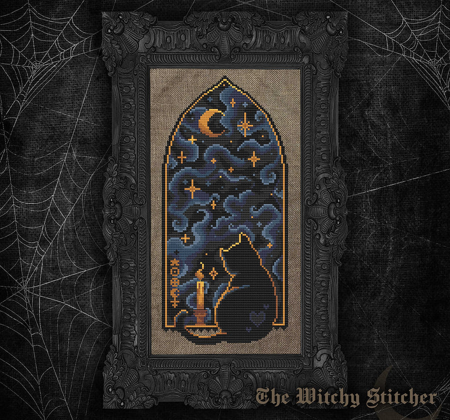 A framed gothic needlepoint or cross-stitch artwork featuring a black cat sitting by a candle under a crescent moon and stars, set against a dark ornate frame. The piece is displayed on a dark textured background with spiderweb graphics and the text 'The Witchy Stitcher' at the bottom.