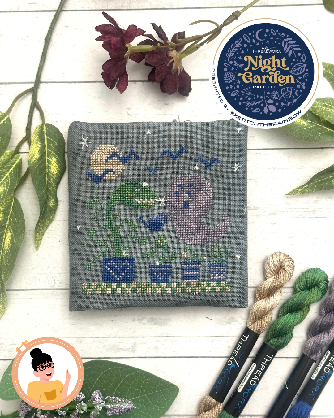 a purple ghost goes out in the full moon to water his plants, only to find a giant carniverous plant waiting for him! blue bats fly overhead stitched on gray fabric with silver sparkles