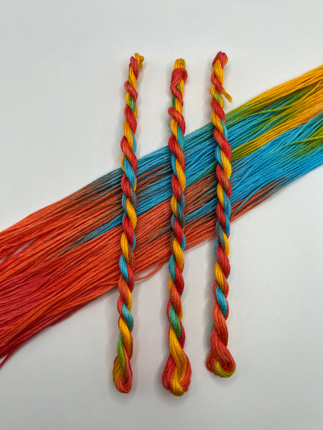 Colorful braided threads on a white background