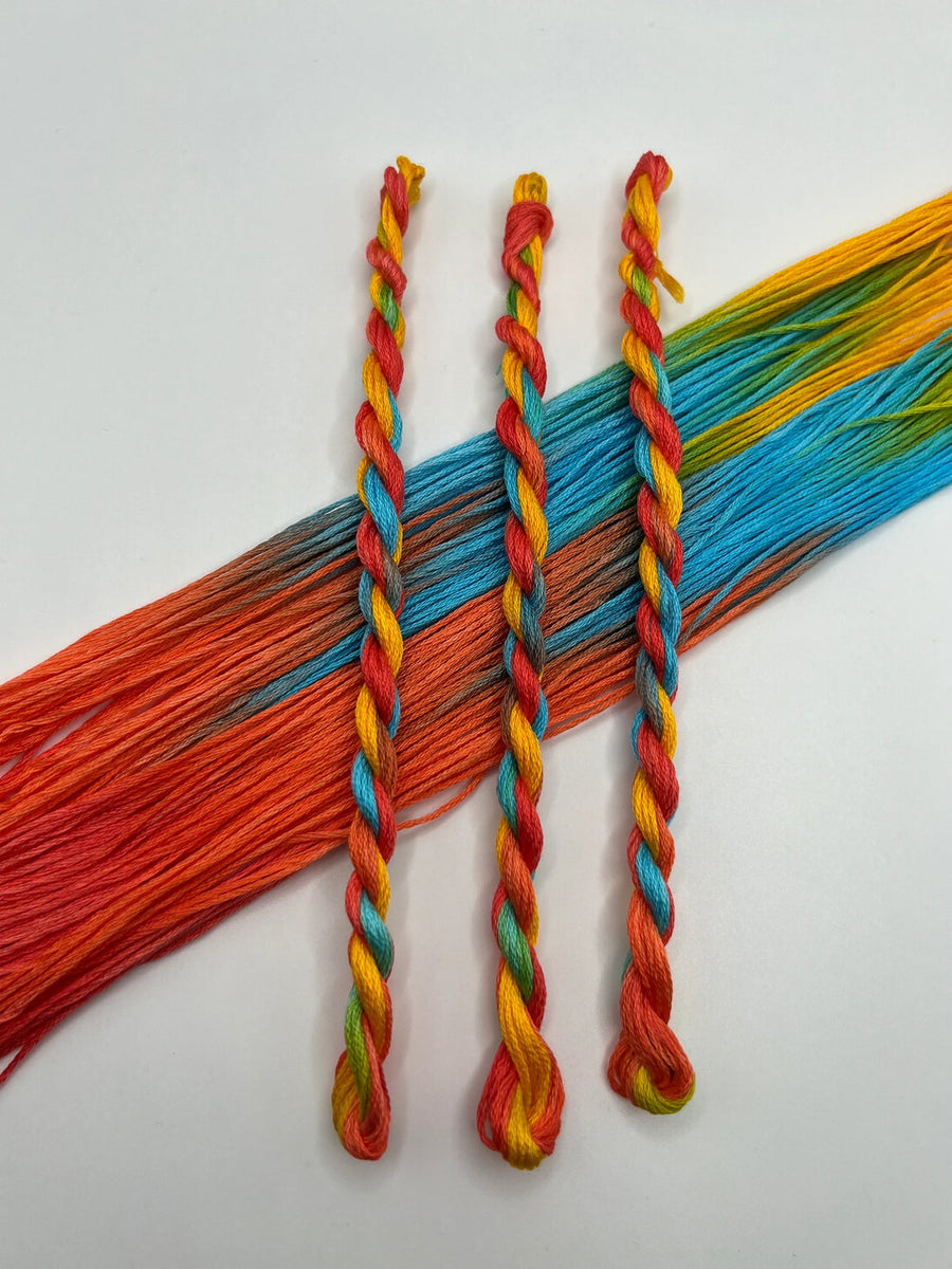 Colorful braided threads on a white background