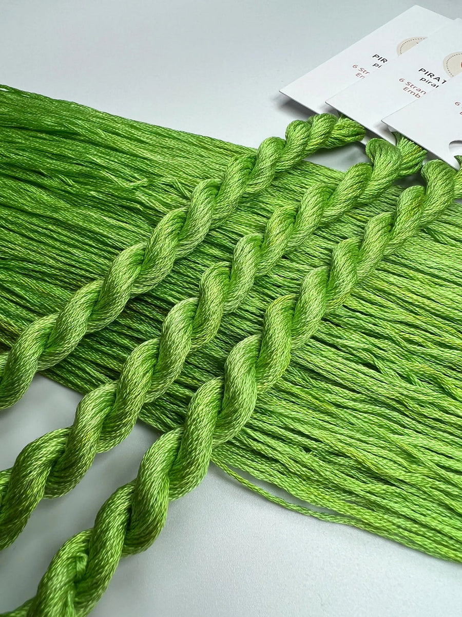 Green embroidery floss on a white background with a label.