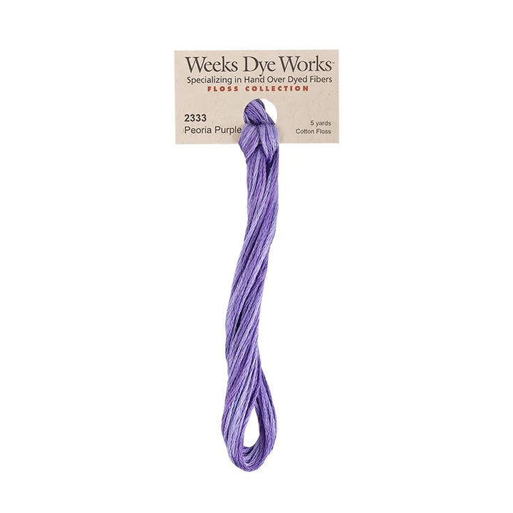 A bundle of Weeks Dye Works Floss Collection cotton embroidery thread in the color Peonia Purple, attached to its original kraft paper packaging label.