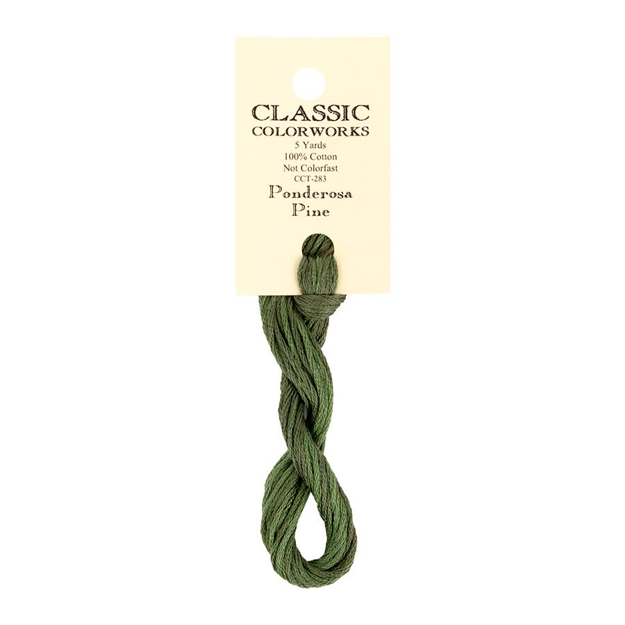 A single skein of Classic Colorworks embroidery floss in the shade Ponderosa Pine, attached to its cream-colored paper header card, shown against a plain white background.