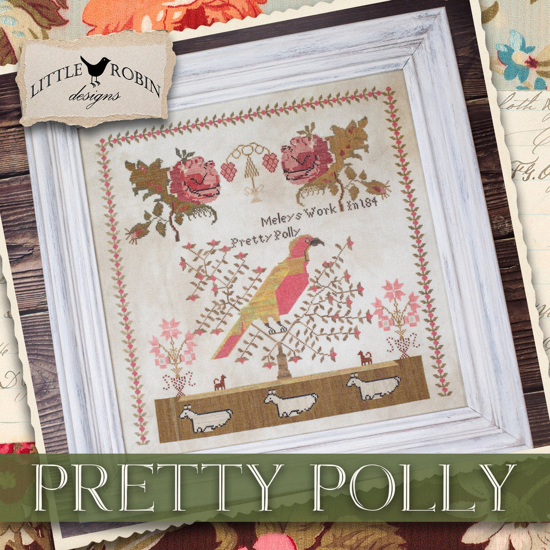 Framed cross-stitched piece with a bird design and 'Little Robin Designs' branding.