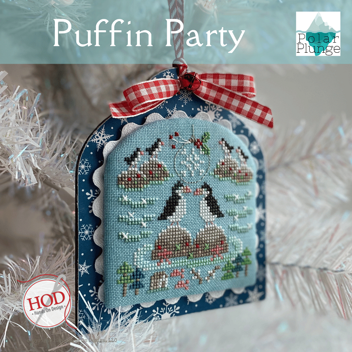 Cross-stitched ornament with penguins and a checkered ribbon, branded 'Polar Plunge' and 'HOD'.