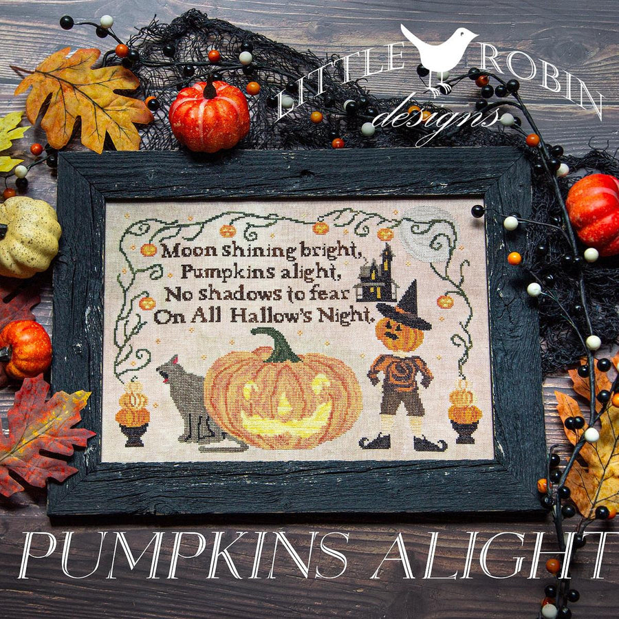 Halloween-themed cross-stitch pattern with pumpkins, leaves, and a scarecrow on a wooden background.