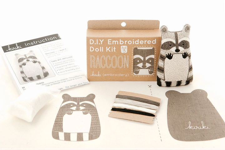 DIY embroidered doll kit with raccoon design on a white background