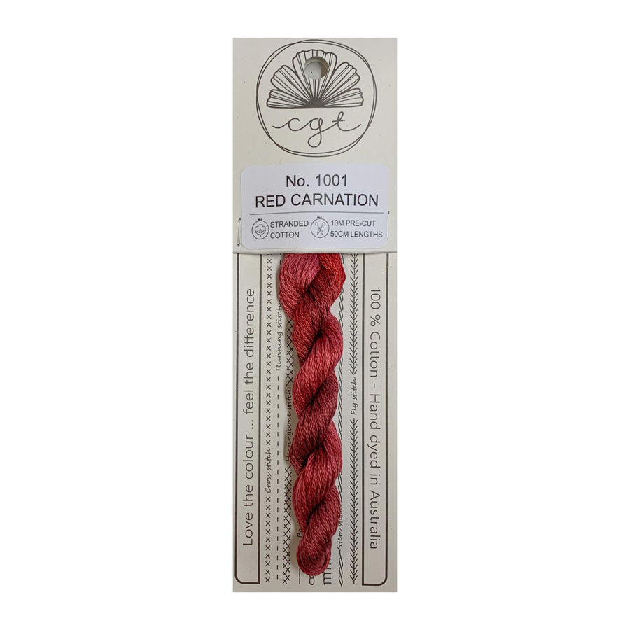 A skein of red hand-dyed cotton cross stitch and embroidery floss labeled 'No. 1001 RED CARNATION' from Cottage Garden Threads.