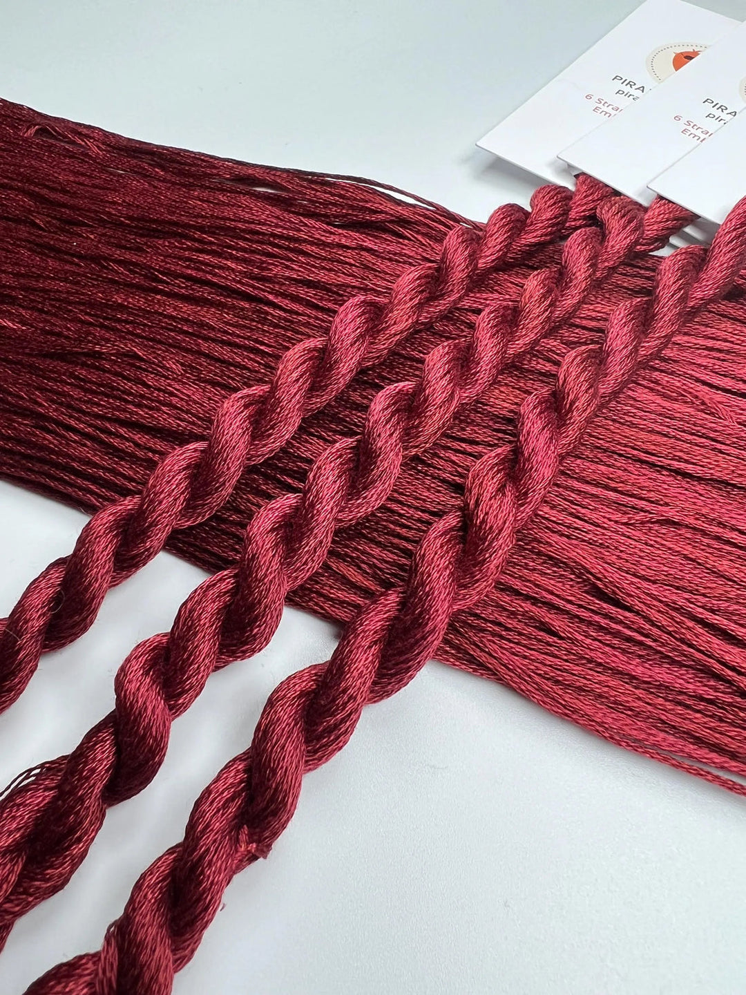 Red braided yarn on a white background