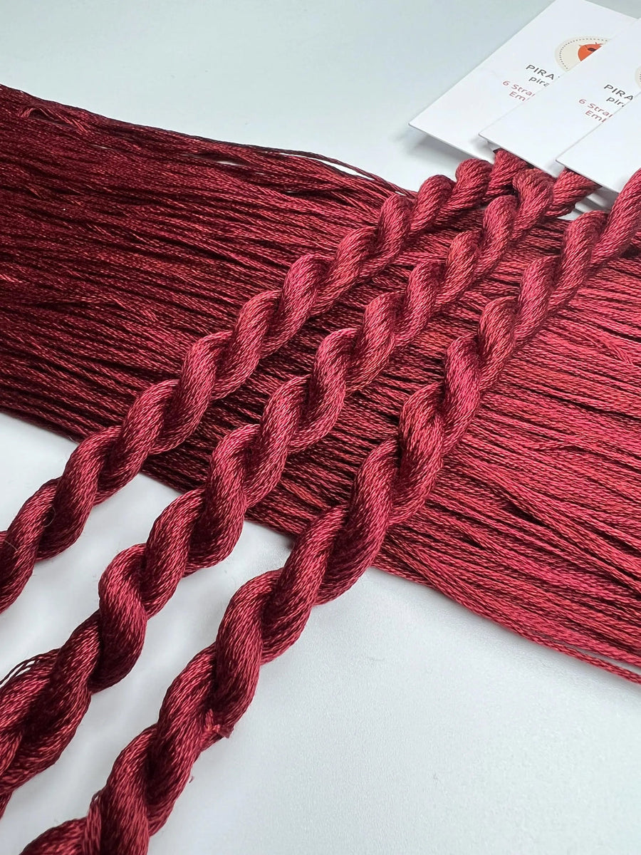 Red braided yarn on a white background