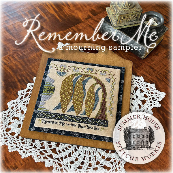 Mourning sampler with decorative elements on a wooden surface, featuring 'Summer House Stitche Workes' branding.