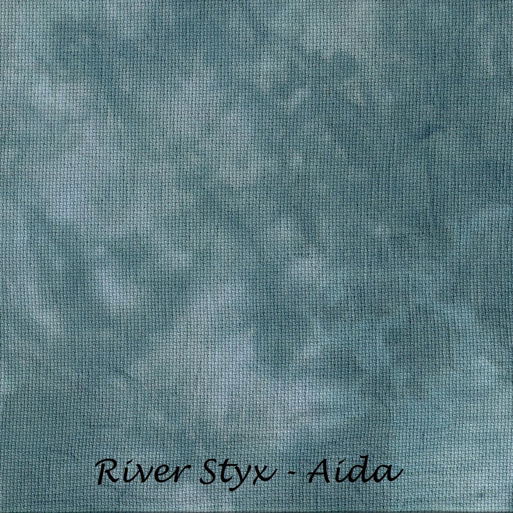 A close-up of a mottled blue and teal fabric texture with the text 'River Styx - Aida' printed at the bottom.