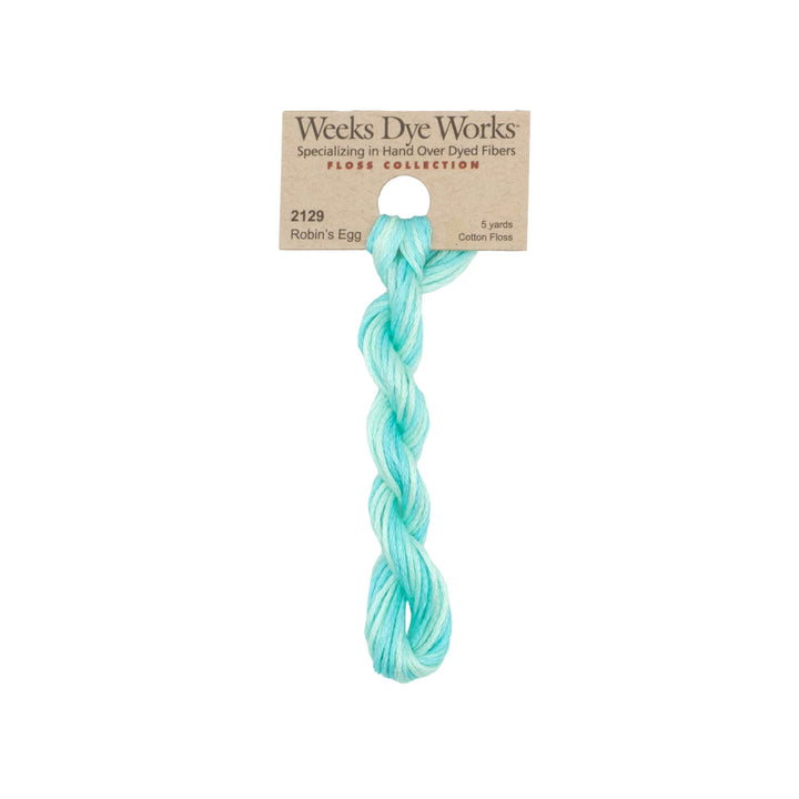 A single twisted skein of Weeks Dye Works Robin's Egg cotton floss in a light aqua/mint color, attached to its original kraft paper header card.