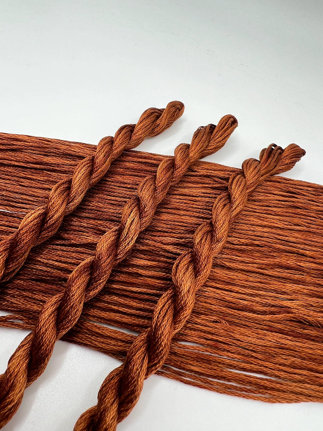 Brown braided yarn on a white background