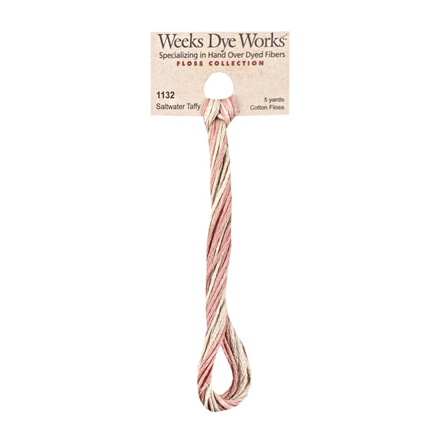A single skein of Weeks Dye Works Saltwater Taffy cotton fiber, showing the light pink and cream twisted thread hanging from itsacardboard tag against a plain white background.